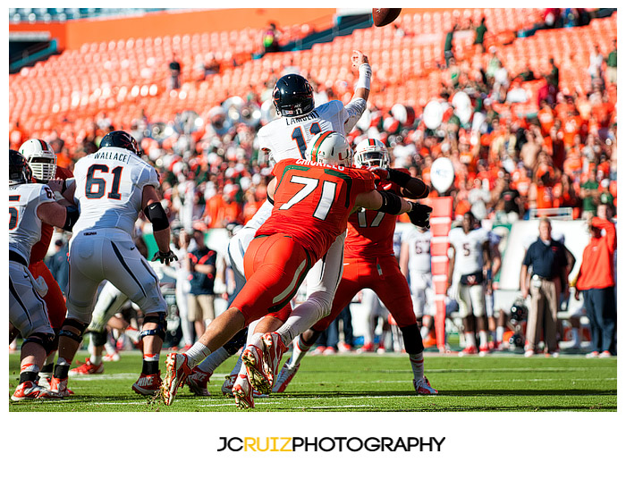 Hurricanes defensive lineman #71, Anthony Chickillo, disrupts the pass attempt of Virginia QB #11, Greyson Lambert