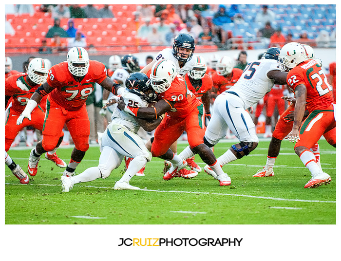 Hurricanes lineman, #90 Ufomba Kamalu, wraps up Virginia RB, #25 Kevin Parks