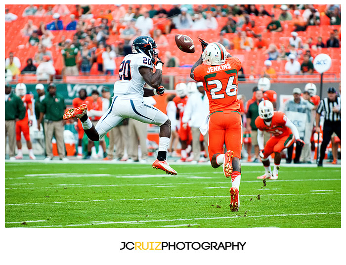 Hurricanes DB #26, Rayshawn Jenkins, tries to haul in a tipped pass intended for #20, Tim Smith, of the Cavaliers
