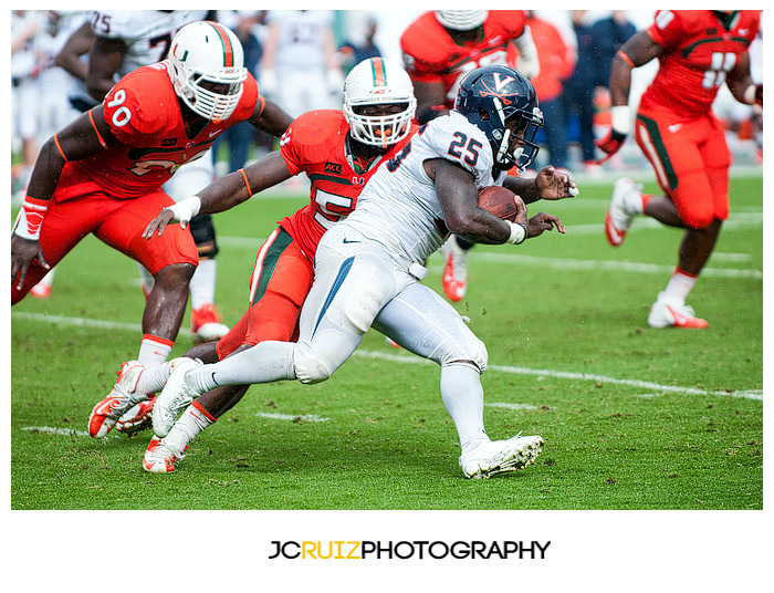 Virginia RB #25, Kevin Parks, runs past Miami LB #59, Jimmy Gaines
