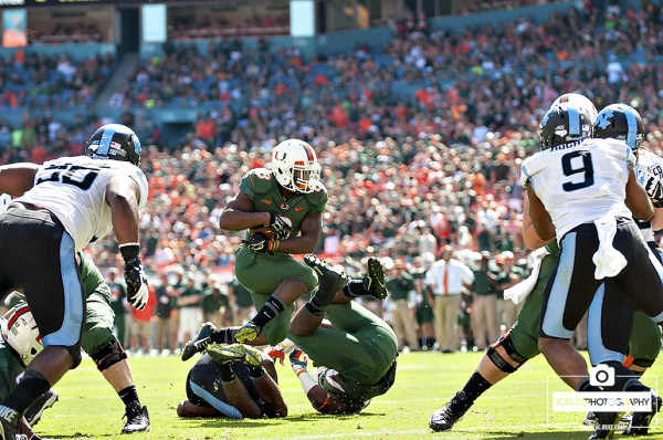 Duke Johnson leaps over players on his way to a touchdown