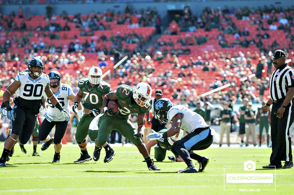 Joe Yearby tries to juke a North Carolina defender
