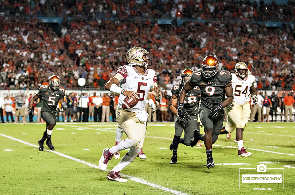 Florida State QB #5 Jameis Winston tries to evade Miami Hurricanes DE #9, Chad Thomas