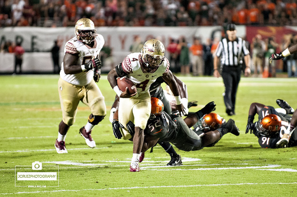 Florida State RB #4, Dalvin Cook, eludes the tackle of Miami LB #52, Denzel Perryman, for the game winning touchdown