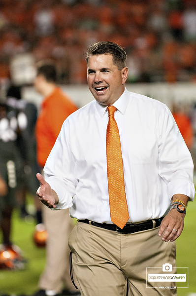 Miami Hurricanes Head Coach, Al Golden, greets his team during pre-game stretches