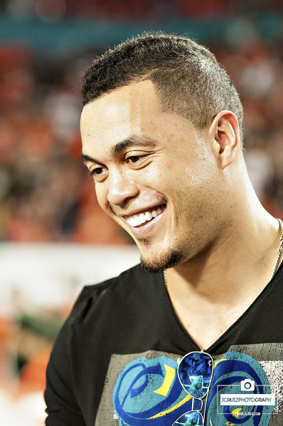 Miami Marlins outfielder, Giancarlo Stanton, answers media questions on the sideline prior to the Miami Hurricanes vs. FSU game