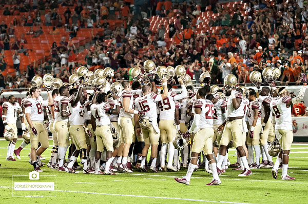 Florida State Seminoles get together after stretching drills