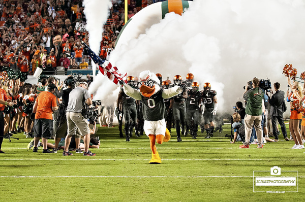 Sebastian the Ibis Miami Hurricanes team onto the field