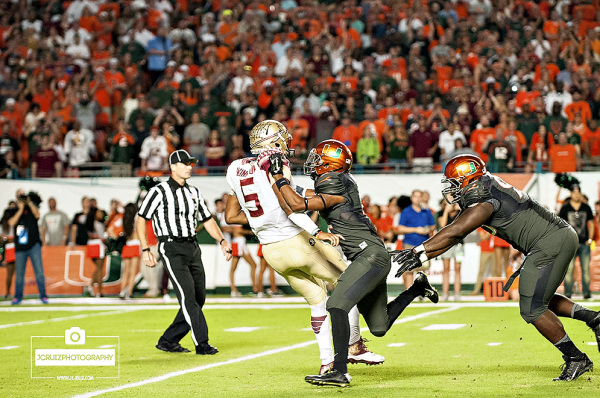 Miami Hurricanes DB #2, Deon Bush, greets Florida State QB #5 Jameis Winston