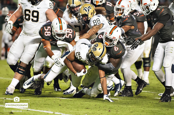 Jamal Carter and Darrion Owens tackle Rachid Ibrahim