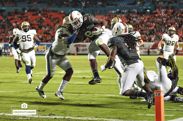 Duke Johnson leaps over defenders