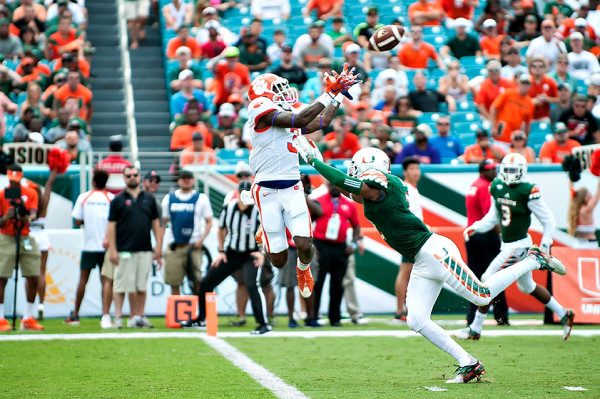 Clemson WR #3, Artavis Scott, goes up for a pass with Miami Hurricanes safety #2, Deon Bush defending