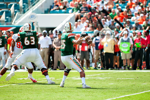 Miami Hurricanes QB #15, throws a pass against Clemson