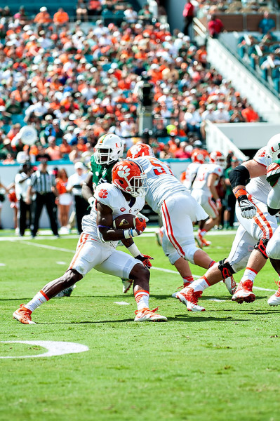 Clemson Tigers RB #9, Wayne Gallman, attempts to rush past the Miami Hurricanes defense