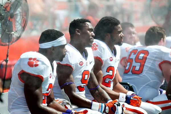 Clemson Tigers players cool off under the fan at Sunlife Stadium