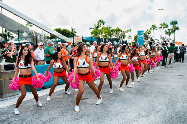 Miami Hurricane cheerleaders keep the crowd entertained as they await the team's arrival
