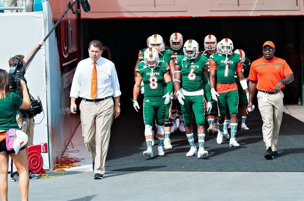 Miami Headcoach, Al Golden, leads his team out before the game