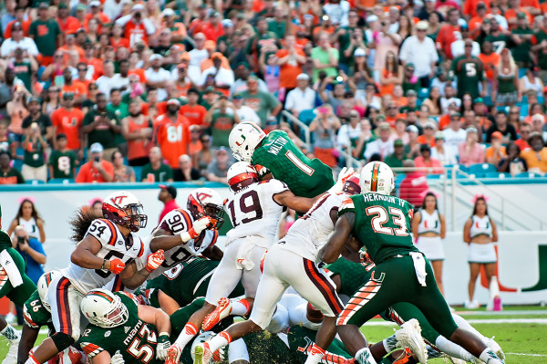 Miami Hurricanes RB #1, Mark Walton, tries to jump over the pile for a touchdown