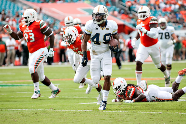 Georgia Tech running back, Clinton Lynch rushes against the Miami defense