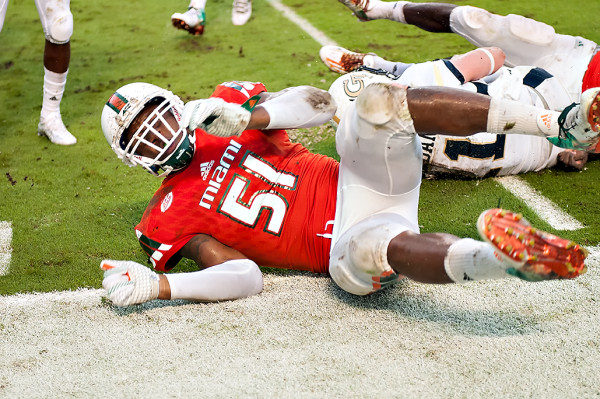 Miami lineback Juwon Young slides towards me after making a tackle