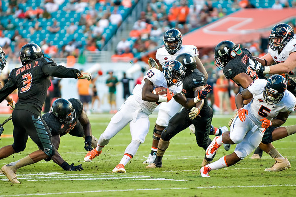 Virginia RB Olamide Zaccheaus tries to evade the Hurricanes defense