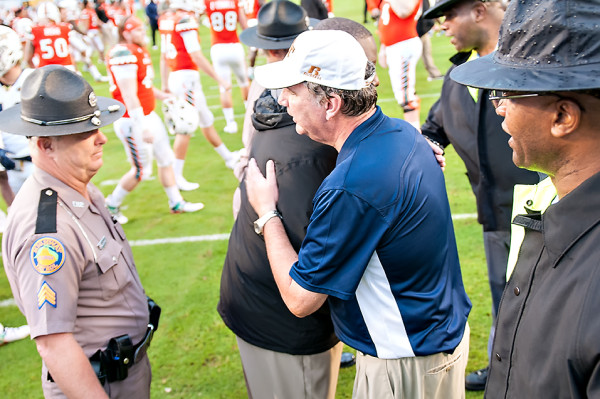 Both head coaches shake hands after the game