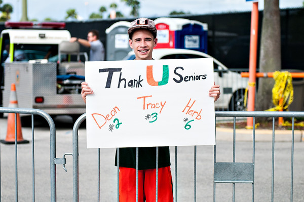 A young Hurricane fan shows his support for the seniors on Senior Day