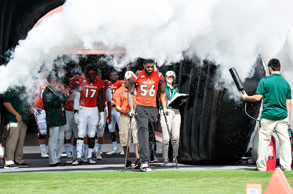 Injured linebacker, Raphael Kirby, walks through the smoke