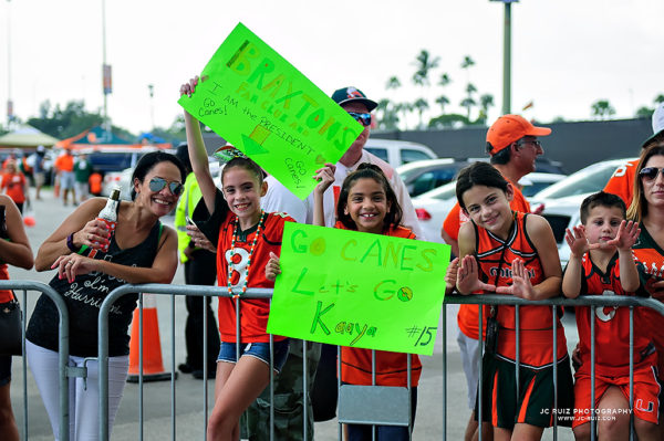 Young fans wait for the Miami Hurricanes to arrive