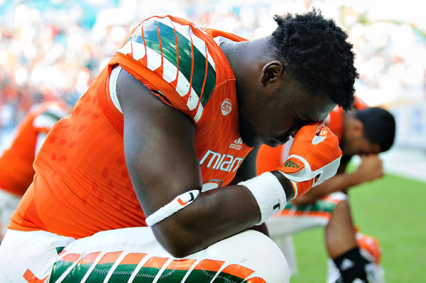 Chad Thomas says a prayer before the start of the game
