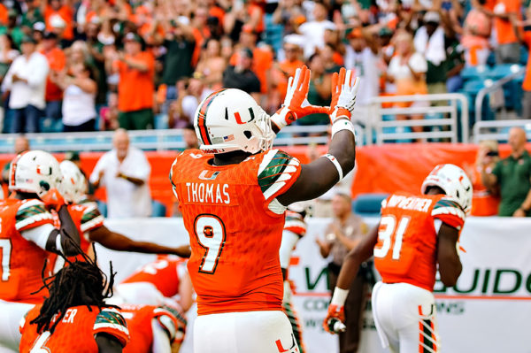 Chad Thomas throws up the "U" prior to the game