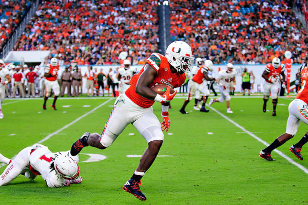 Hurricanes TE, Christopher Herndon, eludes a tackle and heads up the sideline
