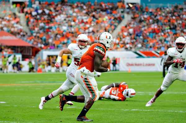 Hurricanes RB, Joe Yearby, heads up field after catching a pass from Brad Kaaya