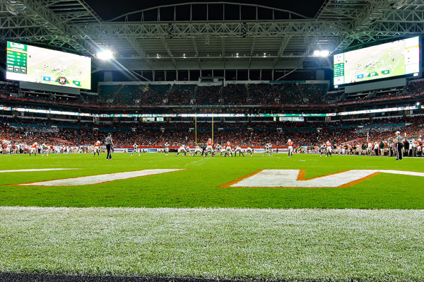 The Miami Hurricanes line up under the bright likes of Hard Rock Stadium