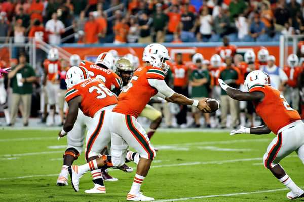 Miami QB, Brad Kaaya, hands off to Joe Yearby