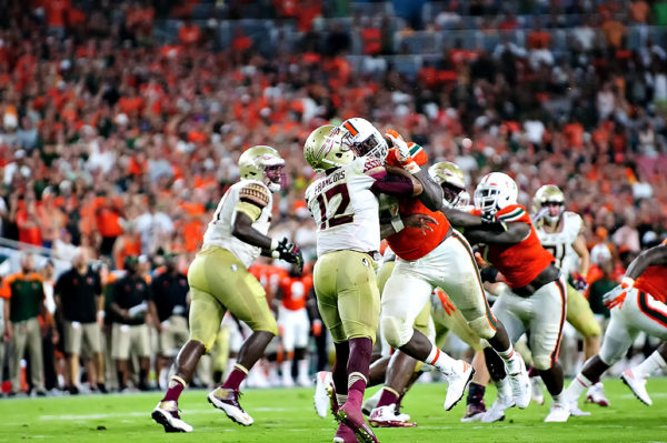 Hurricanes DL, Chad Thomas, gets up close and personal with Florida State QB, Deondre Francois