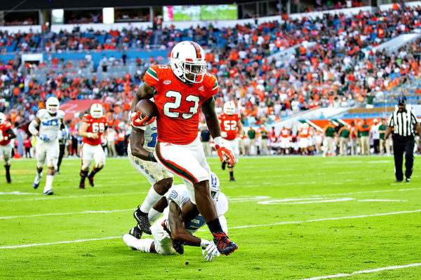 Hurricanes TE, Christopher Herndon, tries to elude the tackle from a FSU defender