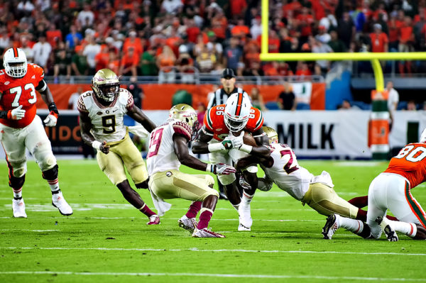 Hurricanes TE, David Njoku, tries to break through two FSU defenders