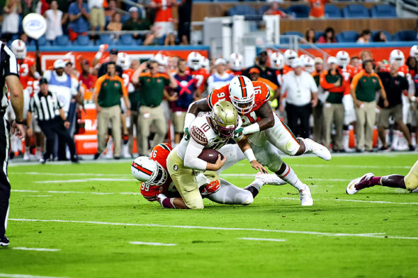 Hurricane defenders, Joe Jackson and Gerald Willis, sack Florida State QB, Sean Maguire