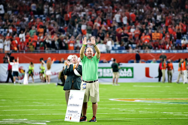 Former Hurricanes QB and great Gino Torretta throws up the "U"