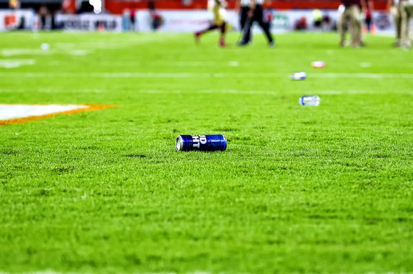 Bottles and beer cans line the field after Miami Hurricanes fans threw them in protest to a whistle by the officials