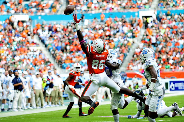 The pass from Brad Kaaya is just out of the reach of Hurricanes TE, David Njoku