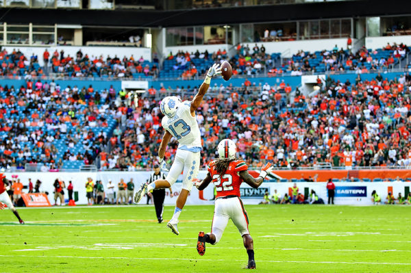 Mack Hollins, Tar Heels WR, reaches for pass as Sheldrick Redwine looks on