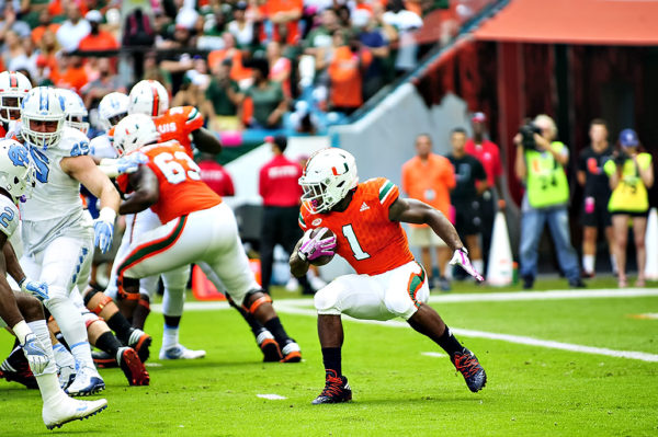 Hurricanes RB, Mark Walton, stops and cuts as he tries to find a hole to run through