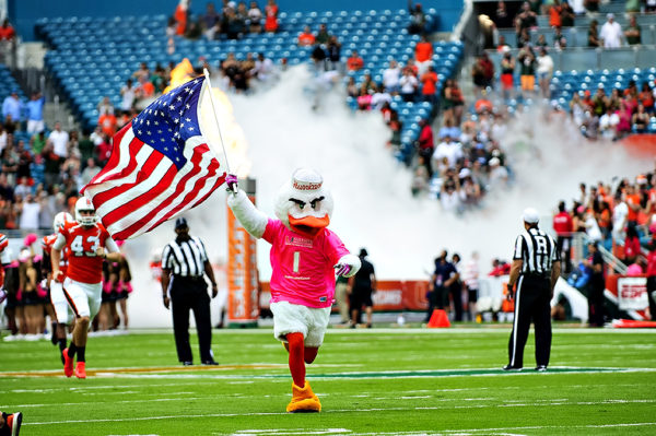 Sebastian leads the team out wearing a pink breast cancer t-shirt