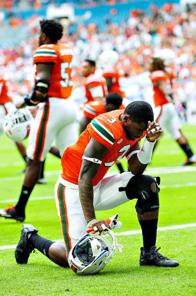 Hurricanes WR, Stacy Coley, says a prayer prior to the game