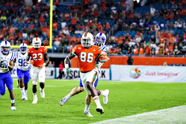 Hurricanes TE, David Njoku, runs up the sideline for a touchdown