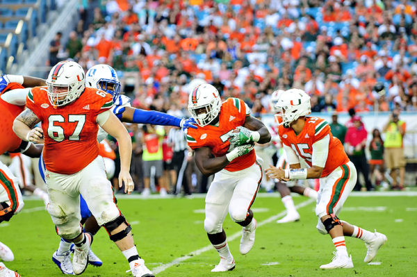 Hurricanes RB, Gus Edwards, rushes against Duke