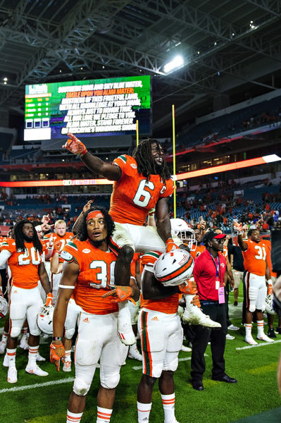 Senior, Jamal Carter, is hoisted by his teammates