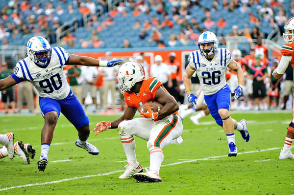 Hurricanes RB, Mark Walton, stops to make a cut